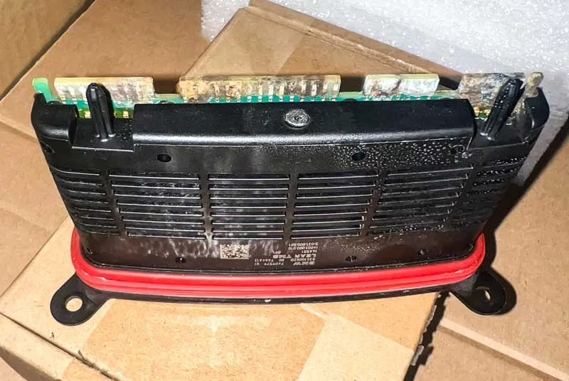 backside of the bmw headlight module showing water damage