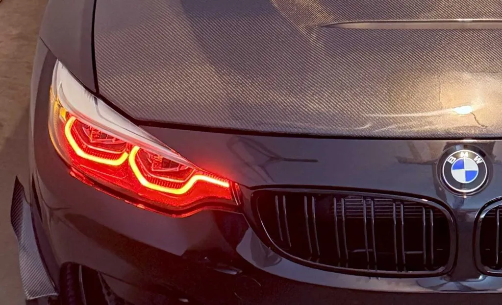 poor carbon fiber hood fitment shown on black f82 bmw m4