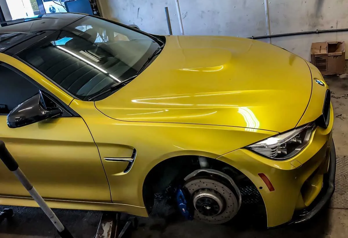 bmw m4 at a tire shop installing Michelin Pilot Super Sport tires