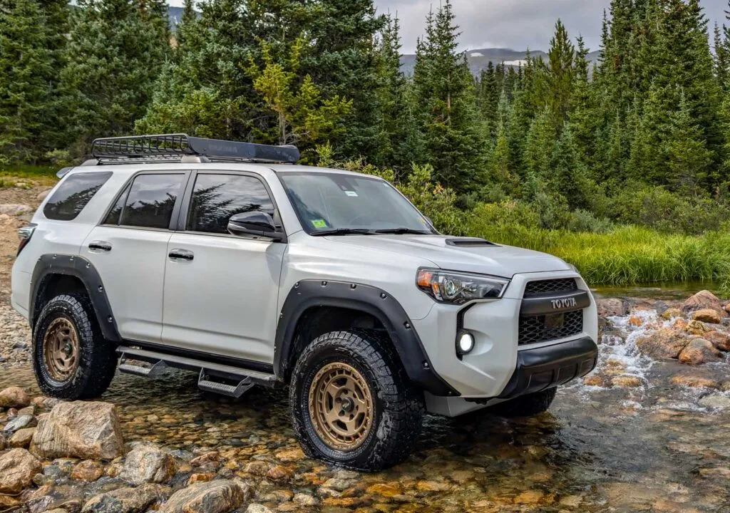 falken wildpeak at4w tires on a toyota 4runner that is crossing a small creek